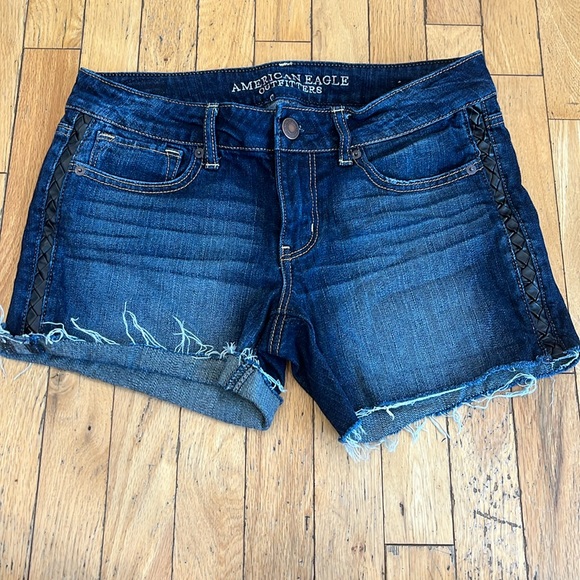 American Eagle Outfitters Pants - AMERICAN EAGLE leather braided hip, distressed hem stretch shorts. Size 8. EUC.